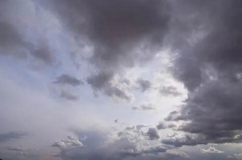 Cumulus clouds soaring high in the blue sky Stock Photos