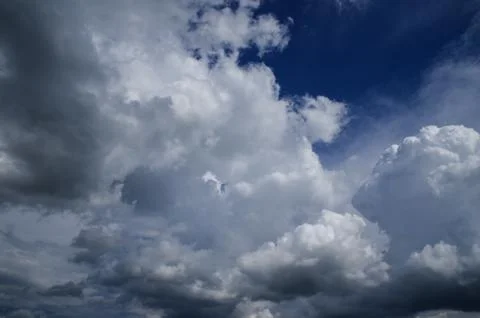 Cumulus clouds soaring high in the blue sky Stock Photos