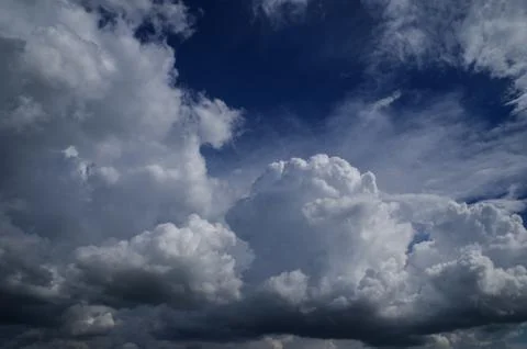 Cumulus clouds soaring high in the blue sky Stock Photos