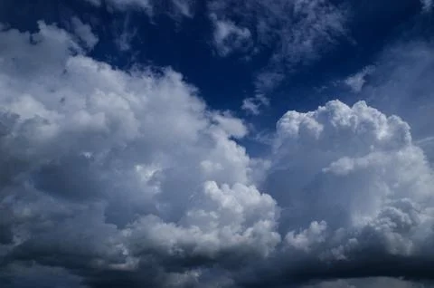 Cumulus clouds soaring high in the blue sky Stock Photos