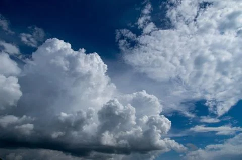 Cumulus clouds soaring high in the blue sky Stock Photos