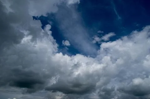 Cumulus clouds soaring high in the blue sky Stock Photos