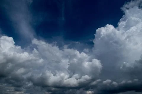 Cumulus clouds soaring high in the blue sky Stock Photos