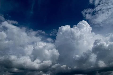 Cumulus clouds soaring high in the blue sky Stock Photos