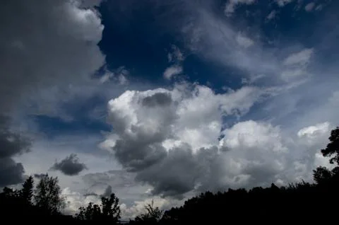 Cumulus clouds soaring high in the blue sky Stock Photos