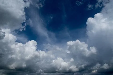 Cumulus clouds soaring high in the blue sky Stock Photos