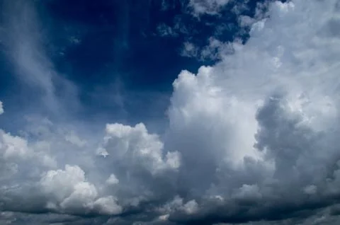 Cumulus clouds soaring high in the blue sky Stock Photos