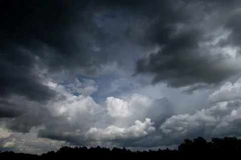 Cumulus clouds soaring high in the blue sky Stock Photos