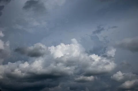 Cumulus clouds soaring high in the blue sky Stock Photos