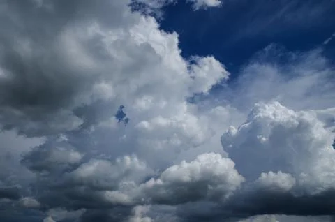 Cumulus clouds soaring high in the blue sky Stock Photos