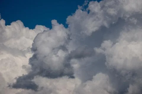Cumulus clouds soaring high in the blue sky Stock Photos