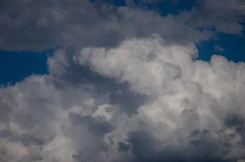 Cumulus clouds soaring high in the blue sky Stock Photos