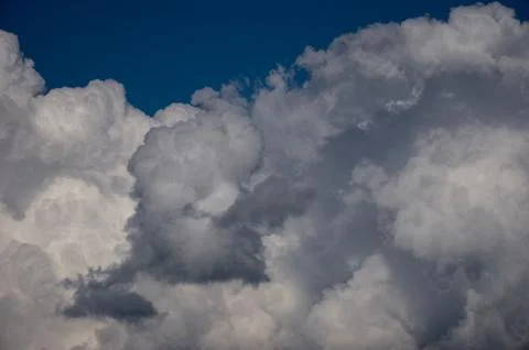 Cumulus clouds soaring high in the blue sky Stock Photos