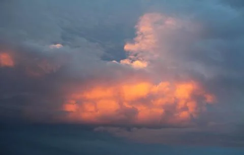 Cumulus clouds at sunset Stock Photos