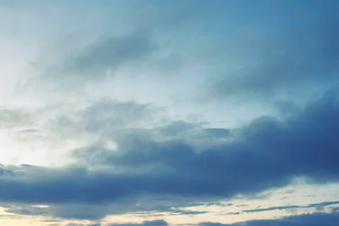 Cumulus clouds of the sunset with the sunset Blue sky blurred background defo Stock Photos