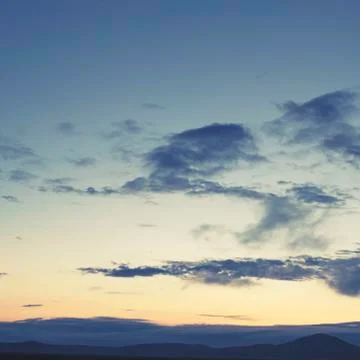 Cumulus clouds of the sunset with the sunset Blue sky blurred background defo Stock Photos