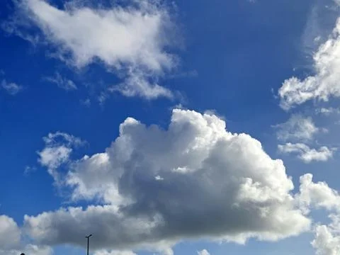 Cumulus Clouds Under an Azure Sky with Street Light Stock Photos