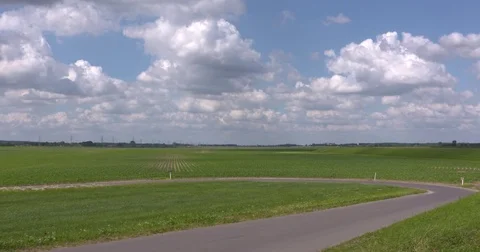 Cumulus sky above flat and void high-water channel landscape Stock Footage 77120368