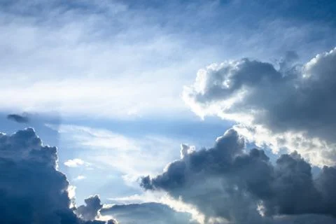 Cumulus sunset clouds with sun setting down Stock Photos