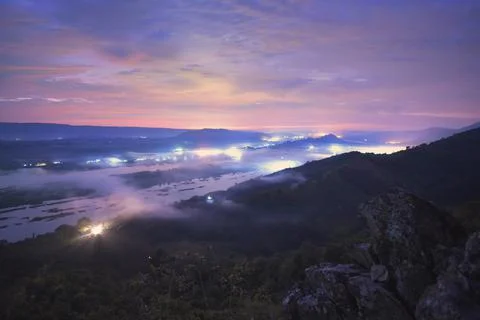 Cumulus sunset clouds with sun setting down Stock Photos