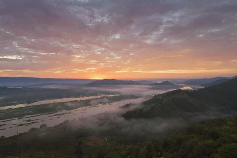 Cumulus sunset clouds with sun setting down Stock Photos