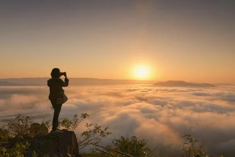 Cumulus sunset clouds with sun setting down Stock Photos