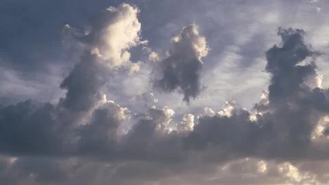 Cumulus sunset clouds with sun setting down. 스톡 사진
