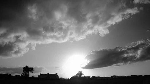 Cumulus in sunset running fast over the countryside. Black and white timelapse. Stock Footage 86896566