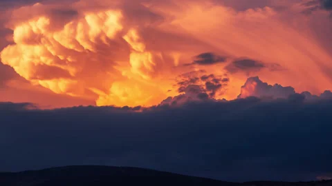 Cumulus taking of an anvill shape with dramatic sunset colors 4K ProRes 4444 Stock Footage 310452958