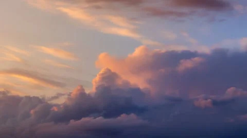 Cumulus type clouds dissipating at sunset Stock Footage 249187812