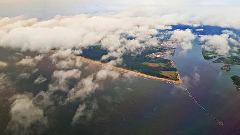 Cumulus white clouds from the side of flying passenger plane Stock Photos
