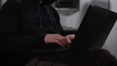 The cunning man, dressed in a black jacket and a hood on his head finishes to Video stock 72424534