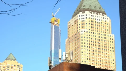Cunstruction crane working on a skyscraper in new york city Stock Footage 125128637