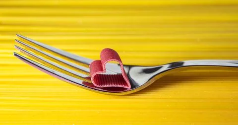 Cuoricini Italian pasta on a fork on spaghetti background. Stock Photos