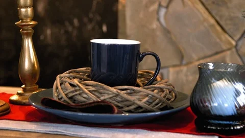 Cup and candle on the table Stock Footage 98516576