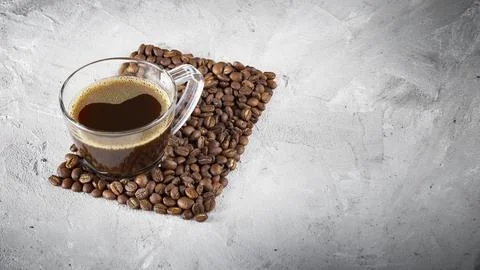 Cup and coffee beans on rustic background, coffee from Colombia Stock Photos
