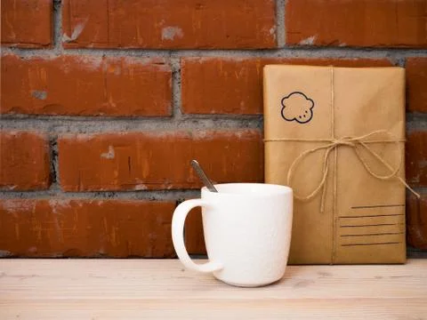 Cup and gift box on table Stock Photos