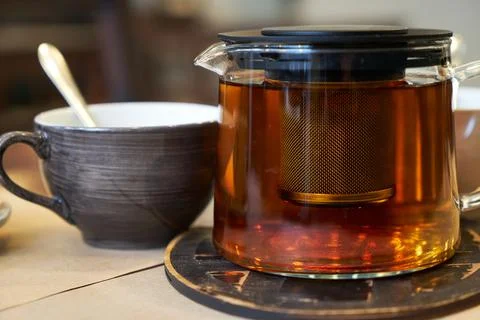 Cup and teapot on a table in a cafe. Stock Photos