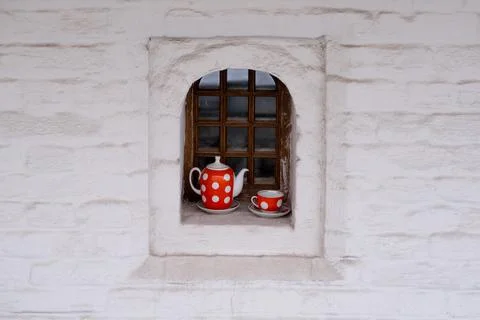 Cup and teapot on the window Stock Photos