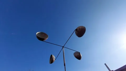 Cup anemometer spinning fast against a clear blue sky Stock Footage 333642908