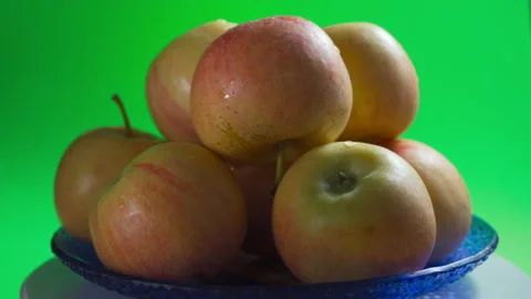 A cup with apples on a green background is spinning Stock Footage 159158565