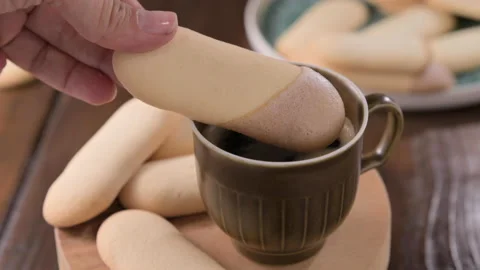 Cup of aromatic black espresso coffee and Cat's tongues These are thin and Video stock 204875558