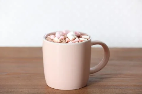 Cup of aromatic cacao with marshmallows on wooden table Stock Photos