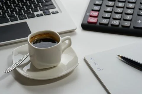 Cup of aromatic espresso coffee computer calculator notepad pen on white back Stock Photos