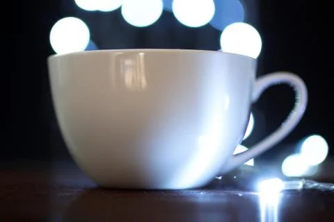 Cup on the background of lights Stock Photos