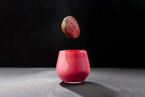 A cup of beet latte on a dark background. Healthy eating alternative to caffeine Photos