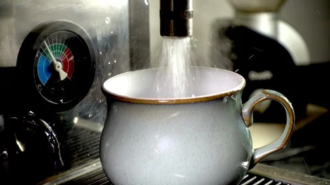 Cup being filled with boiling water from a commercial machine. Stock-Footage 97384129