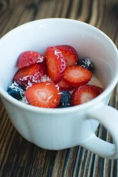 Cup of berries with coconut Stock Photos