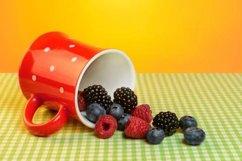 Cup with berries on the table Stock Photos