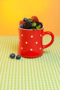 Cup with berries on the table Stock Photos